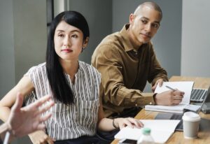 Two people listening in a business meeting