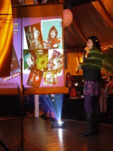 Woman speaking in front of a projected image 