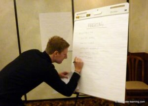 Man writing on a flip chart