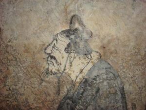 Close up of a fresco showing a man's face. 