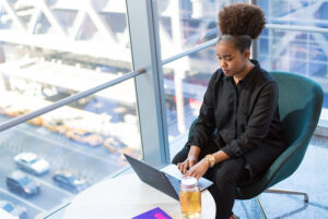 A woman working on a laptop in an office