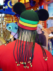 Someone wearing a hat with braids and a Rastafarian color-scheme at the Disney store in Orlando Florida.