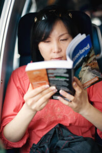 Woman reading a travel guide about Switzerland