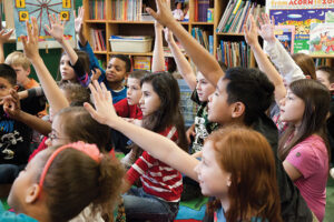 Schoolchildren raising their hands