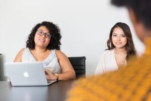 A job candidate sits for a job interview with two interviewers.