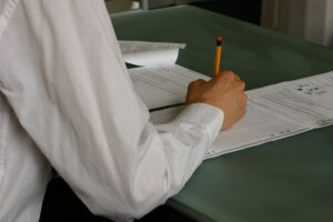 A person taking a test using a scantron.