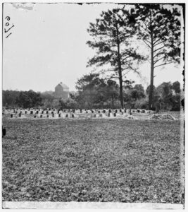 Old image of gravestones in a field.