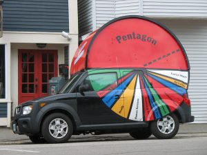 A van with a pie chart painted on the side. The chart represents the US budget, and shows how the pentagon is half the budget.