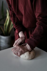 Hands kneading bread dough