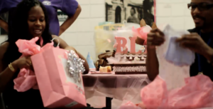 Couple opening gifts at a baby shower