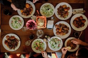 Overhead view of a table with lots of colorful dishes. 