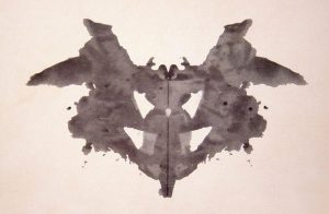 A watercolor Rorschach blot. It's deliberately ambiguous: it could be a butterfly, or a dog, or a face, or many other things.