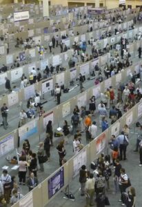 Crowds of people looking at research posters