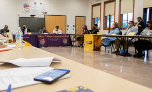 A group of people sitting around a seminar-style table