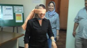 A blindfolded woman playing a game