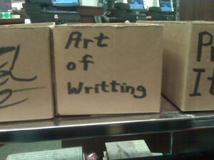 A cardboard box labeled Art of Writting (misspelled Writing)