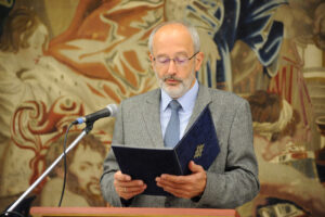 A person reading a speech from a manuscript