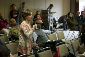 Woman speaking at a town hall meeting