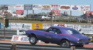 A drag racing car doing a wheelie