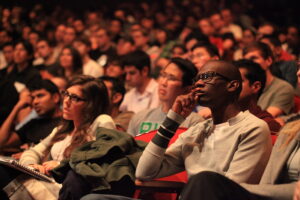 An audience listening to a speaker