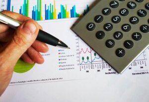 A calculator and charts on a desk