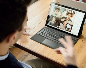 Person on a video conference on a laptop