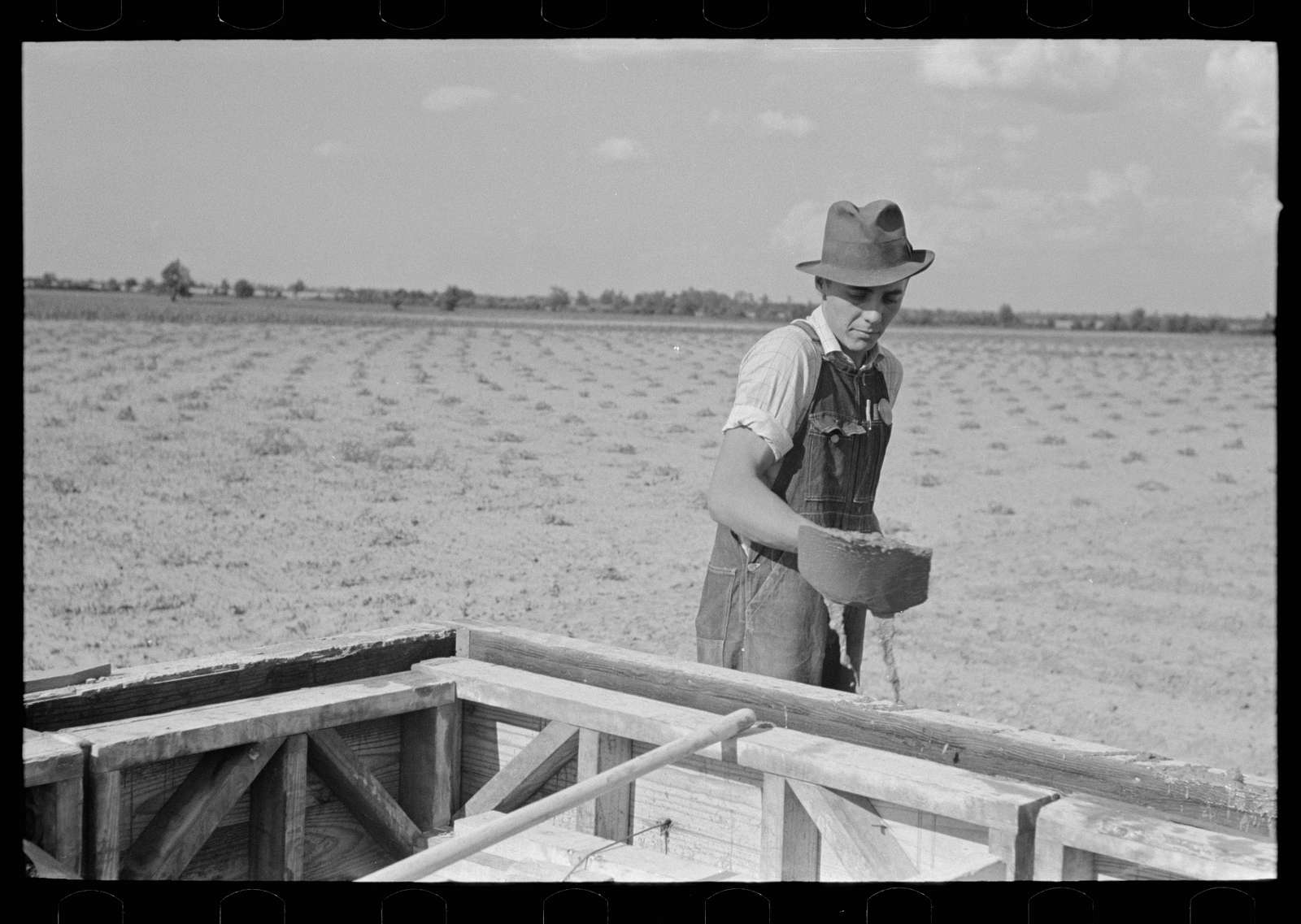 A photograph of a man during the Great Depression era tending to his field.