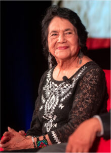 Dolores Huerta seated, receiving an award in 2012.