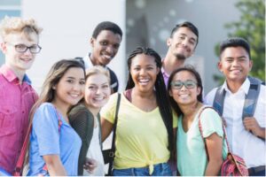 A group of young people smiling for a picture