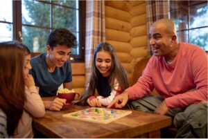 Four people gathered around a table playing a board game