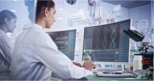 A researcher looking at DNA on a computer