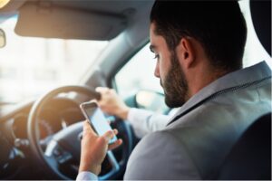 A man using his phone while driving