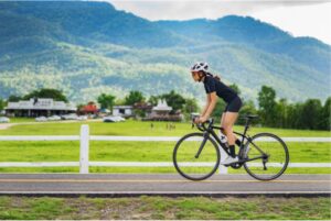 Someone riding a bike on a road in the countryside
