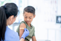 Image of a healthcare worker putting a bandage on a child