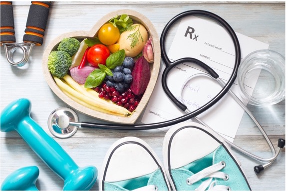 A stethoscope, weights, tennis shoes, a prescription pad, fruits and vegetables in a bowl, and a glass of water.