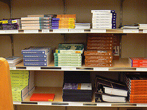 textbooks stacked on shelves in a bookstore