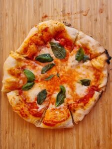 pizza with tomato sauce, cheese, and basil