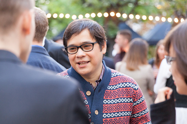 Young man talking in a group of people  