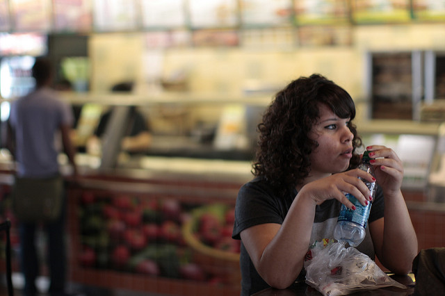 Woman sitting in a campus dining hall