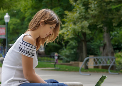 image of a young woman working on a laptop