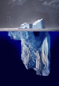 image of iceberg, with most of the ice below the surface of the water.