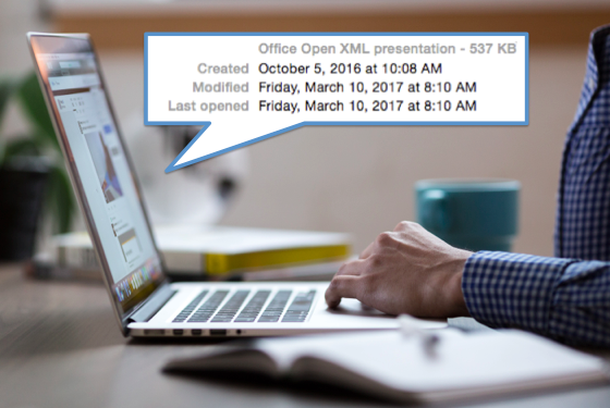  Ręka mężczyzny na ekranie komputera z wyskakującym okienkiem pokazującym historię plików. Jest w nim napisane prezentacja Office Open XML, która została utworzona 5 października 2016 r., następnie zmodyfikowana i ponownie otwarta 10 marca 2017 r.