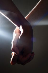 Two people holding hands.