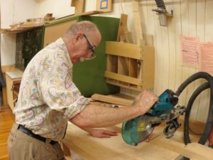 Man using a table saw in a woodshop.