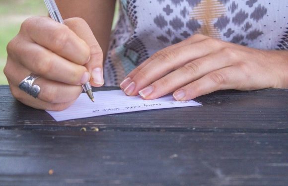 Hand writing a note