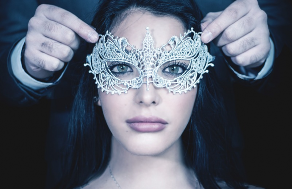 Man placing mask on lady's face