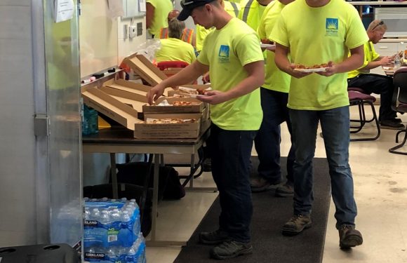 Firefighters getting pizza out of pizza boxes