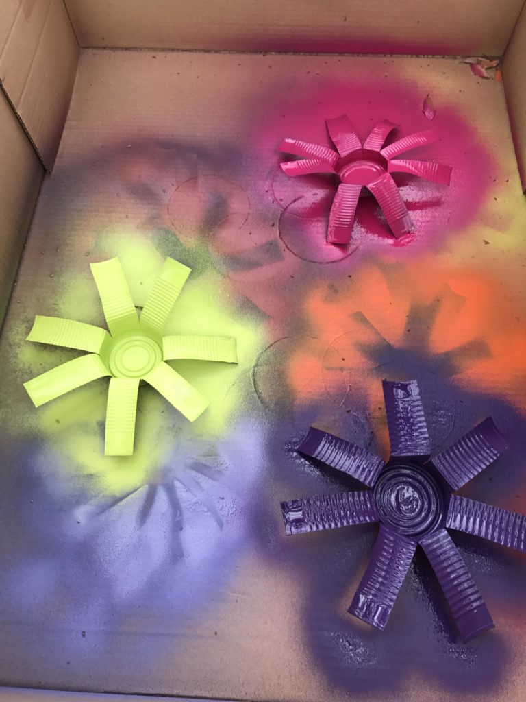 First layer of paint on the tin can flowers