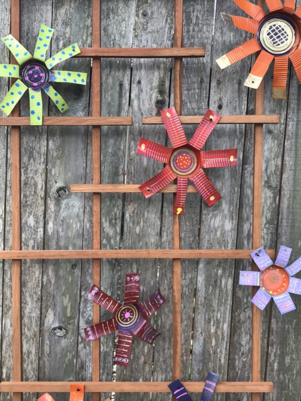 Final tin can flowers with added paint from paint pens to add more interest.
