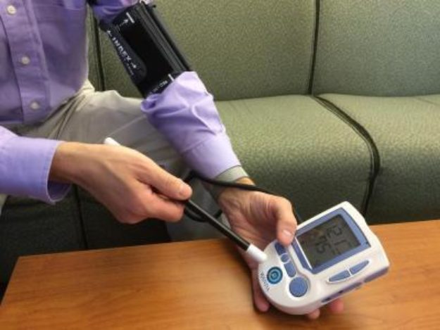 Dartmouth College professor David Kotz demonstrates a commercial prototype of 'Wanda,' which imparts information such as the network name and password of a Wi-Fi access point, onto a blood pressure monitor. (Dartmouth College)